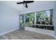 A cozy sunroom offers tranquil views and wood look flooring at 3143 Mission Grove Dr, Palm Harbor, FL 34684