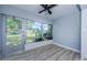 A cozy sunroom offers tranquil views and wood look flooring at 3143 Mission Grove Dr, Palm Harbor, FL 34684