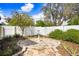 Beautiful backyard featuring a stone patio, mature landscaping, and a privacy fence at 37438 Picketts Mill Ave, Zephyrhills, FL 33542