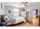 Comfortable bedroom with neutral walls, hardwood floors, and a view of the en-suite bath at 37438 Picketts Mill Ave, Zephyrhills, FL 33542