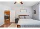 Cozy bedroom with hardwood floors, ceiling fan, and access to the kitchen area at 37438 Picketts Mill Ave, Zephyrhills, FL 33542