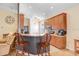 An eat-in kitchen features wood cabinets, appliances, and a breakfast bar with seating at 37438 Picketts Mill Ave, Zephyrhills, FL 33542