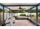 Covered and screened lanai with ceiling fan and brick floor offers a comfortable outdoor living space at 37438 Picketts Mill Ave, Zephyrhills, FL 33542