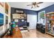 A home office features blue walls, closet, window, and built-in shelving for storage at 37438 Picketts Mill Ave, Zephyrhills, FL 33542