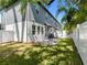 A townhome backyard boasts a stone patio and privacy fence with lush landscaping creating a private outdoor space at 410 S Church Ave, Tampa, FL 33609