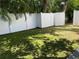 A backyard features a privacy fence, grassy lawn, and stone patio creating a private outdoor space at 410 S Church Ave, Tampa, FL 33609