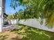 A townhome backyard boasts a stone patio and privacy fence with lush landscaping creating a private outdoor space at 410 S Church Ave, Tampa, FL 33609
