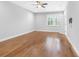 Spacious bedroom with ceiling fan, wood floors, and natural light at 410 S Church Ave, Tampa, FL 33609