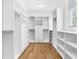 Walk-in closet with custom shelving, drawers, and ample storage space at 410 S Church Ave, Tampa, FL 33609