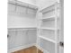 Walk-in closet featuring built-in shelving and hanging rods at 410 S Church Ave, Tampa, FL 33609