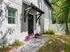 Home entrance showcasing a covered entry, new landscaping, and beautiful potted plants at 410 S Church Ave, Tampa, FL 33609