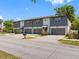 Exterior view of townhome featuring gray and white facade, with unit number 410 visible above the garage at 410 S Church Ave, Tampa, FL 33609