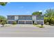 Beautiful townhome exterior featuring a gray and white color scheme and individual garages at 410 S Church Ave, Tampa, FL 33609