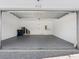 Large, clean garage with overhead storage and a gray floor at 410 S Church Ave, Tampa, FL 33609
