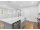 Open concept kitchen with a farmhouse sink, stainless steel appliances and a large island at 410 S Church Ave, Tampa, FL 33609