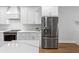 Modern kitchen with white cabinets, marble countertops, stainless appliances, and hardwood floors at 410 S Church Ave, Tampa, FL 33609