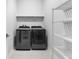 Modern laundry room with shelving and new front load washer and dryer at 410 S Church Ave, Tampa, FL 33609