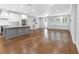 Bright, open-concept living space featuring hardwood floors and a modern kitchen with stainless steel appliances at 410 S Church Ave, Tampa, FL 33609
