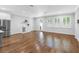 Spacious living room featuring wood floors, light gray walls, built-in bar, and three windows at 410 S Church Ave, Tampa, FL 33609