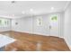 Spacious living room with hardwood floors, neutral walls, and large windows for natural light at 410 S Church Ave, Tampa, FL 33609