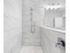 This bathroom features a shower with elegant white marble-style tile and chrome fixtures at 410 S Church Ave, Tampa, FL 33609