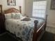 Cozy bedroom featuring a decorative seashell-themed quilt and a bright window at 4794 Cobia Se Dr # D, St Petersburg, FL 33705