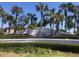 Waterside community entrance with lush landscaping, palm trees, and decorative signage under a clear blue sky at 4794 Cobia Se Dr # D, St Petersburg, FL 33705