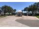 Community entrance gate with guard house, trees, and manicured landscaping on a sunny day at 4794 Cobia Se Dr # D, St Petersburg, FL 33705