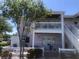 Condo exterior featuring a private patio, balcony, white railings and a view of the landscaped yard at 4794 Cobia Se Dr # D, St Petersburg, FL 33705