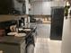 Efficient kitchen offers modern appliances, grey cabinets, and granite countertops at 4794 Cobia Se Dr # D, St Petersburg, FL 33705