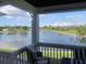 Scenic lake view from a covered porch with chairs, capturing the serene waterfront and lush surroundings at 4794 Cobia Se Dr # D, St Petersburg, FL 33705