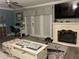 Comfortable living room features a decorative fireplace, modern tv, and an adjacent home office space at 4794 Cobia Se Dr # D, St Petersburg, FL 33705