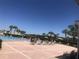 Expansive outdoor pool with lounge chairs and palm trees under a clear blue sky at 4794 Cobia Se Dr # D, St Petersburg, FL 33705