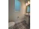 Stylish powder room featuring patterned tile floors, a pedestal sink, and modern lighting at 5235 9Th N Ave, St Petersburg, FL 33710