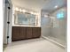 Luxurious bathroom with dual vanity, sleek mirrors, and glass-enclosed shower at 5235 9Th N Ave, St Petersburg, FL 33710