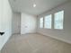Bright, carpeted bedroom with three windows, white trim, and two paneled doors at 5235 9Th N Ave, St Petersburg, FL 33710