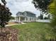 Two-story home featuring a well-maintained lawn and white fence, showcasing curb appeal at 5235 9Th N Ave, St Petersburg, FL 33710