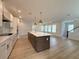 Spacious kitchen featuring a large island, modern lighting, and stainless steel appliances at 5235 9Th N Ave, St Petersburg, FL 33710