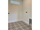 A laundry room with black and white patterned tile flooring and a utility sink at 5235 9Th N Ave, St Petersburg, FL 33710