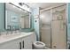 Bathroom with blue accents, including a tiled shower and a white vanity with a marble countertop at 5279 Isla Key S Blvd # 212, St Petersburg, FL 33715