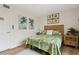 Well-lit bedroom with tropical-themed decor, including palm tree art and a comfortable bed at 5279 Isla Key S Blvd # 212, St Petersburg, FL 33715