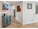 Bright hallway with wood floors leading to kitchen, enhanced by a decorative console table at 5279 Isla Key S Blvd # 212, St Petersburg, FL 33715