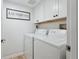 Bright laundry room features white cabinets, modern appliances, and stylish decor at 5279 Isla Key S Blvd # 212, St Petersburg, FL 33715