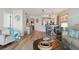 Open-concept living room featuring beach-themed decor, wood floors, and a breakfast bar into the kitchen at 5279 Isla Key S Blvd # 212, St Petersburg, FL 33715