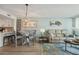 Open-concept living area with a cozy sofa, a dining area, and stylish coastal-themed decor at 5279 Isla Key S Blvd # 212, St Petersburg, FL 33715