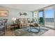 Charming living area with comfortable seating, ocean-inspired accents, and balcony access at 5279 Isla Key S Blvd # 212, St Petersburg, FL 33715