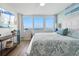 Bright main bedroom with blue accents, water view, and lots of natural light at 5279 Isla Key S Blvd # 212, St Petersburg, FL 33715