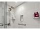 Shower with white subway tile, dual shower heads, a built-in niche, and grab bars at 5279 Isla Key S Blvd # 212, St Petersburg, FL 33715