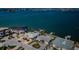 Aerial view of waterfront homes with swimming pools and docks on a sunny day near a blue ocean at 5434 Oakhurst Dr, Seminole, FL 33772