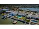 Aerial view featuring waterfront homes with private docks, pools, and lush landscaping within a coastal neighborhood at 5434 Oakhurst Dr, Seminole, FL 33772